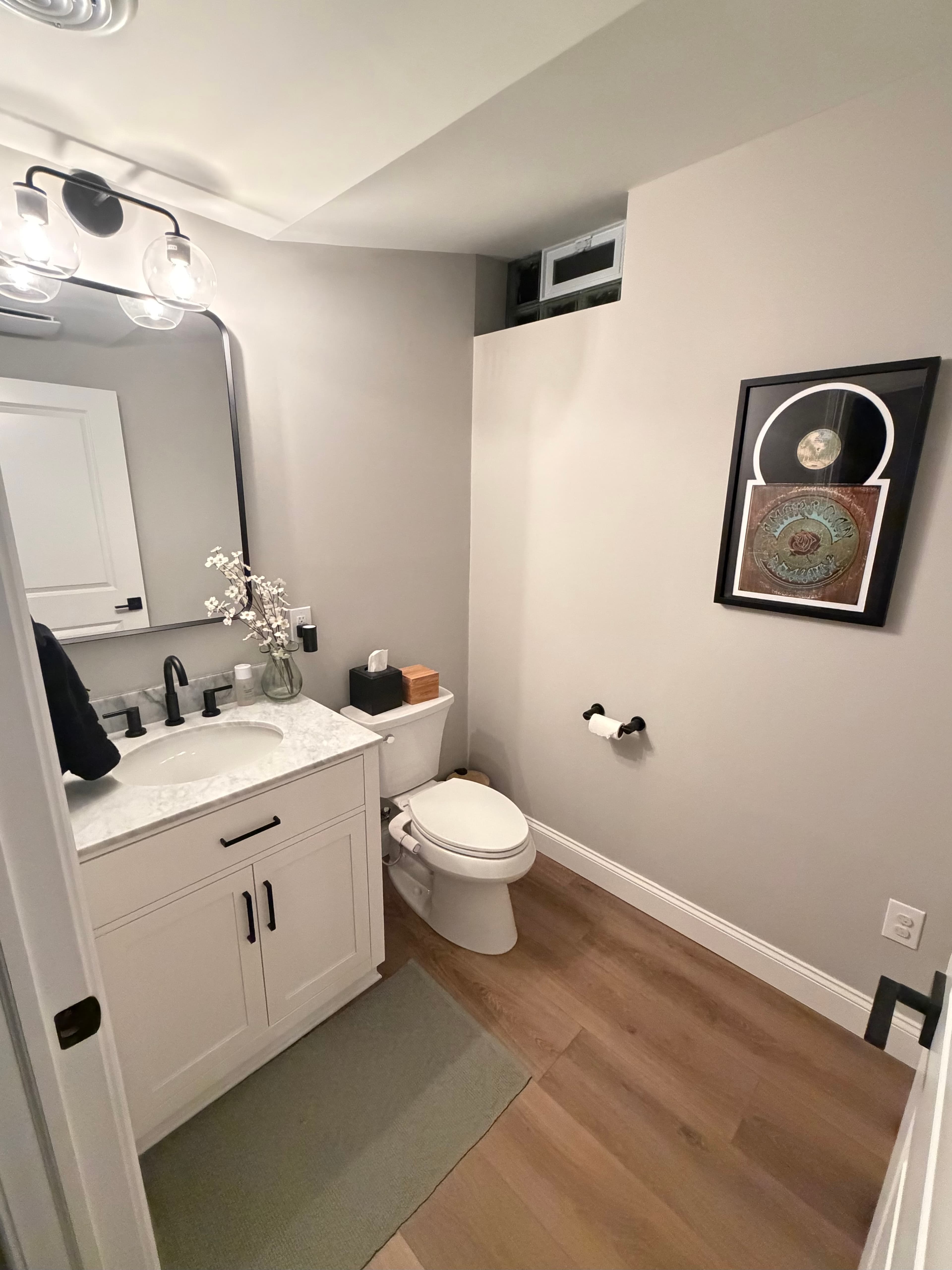 Finished basement bathroom with marble vanity and modern fixtures